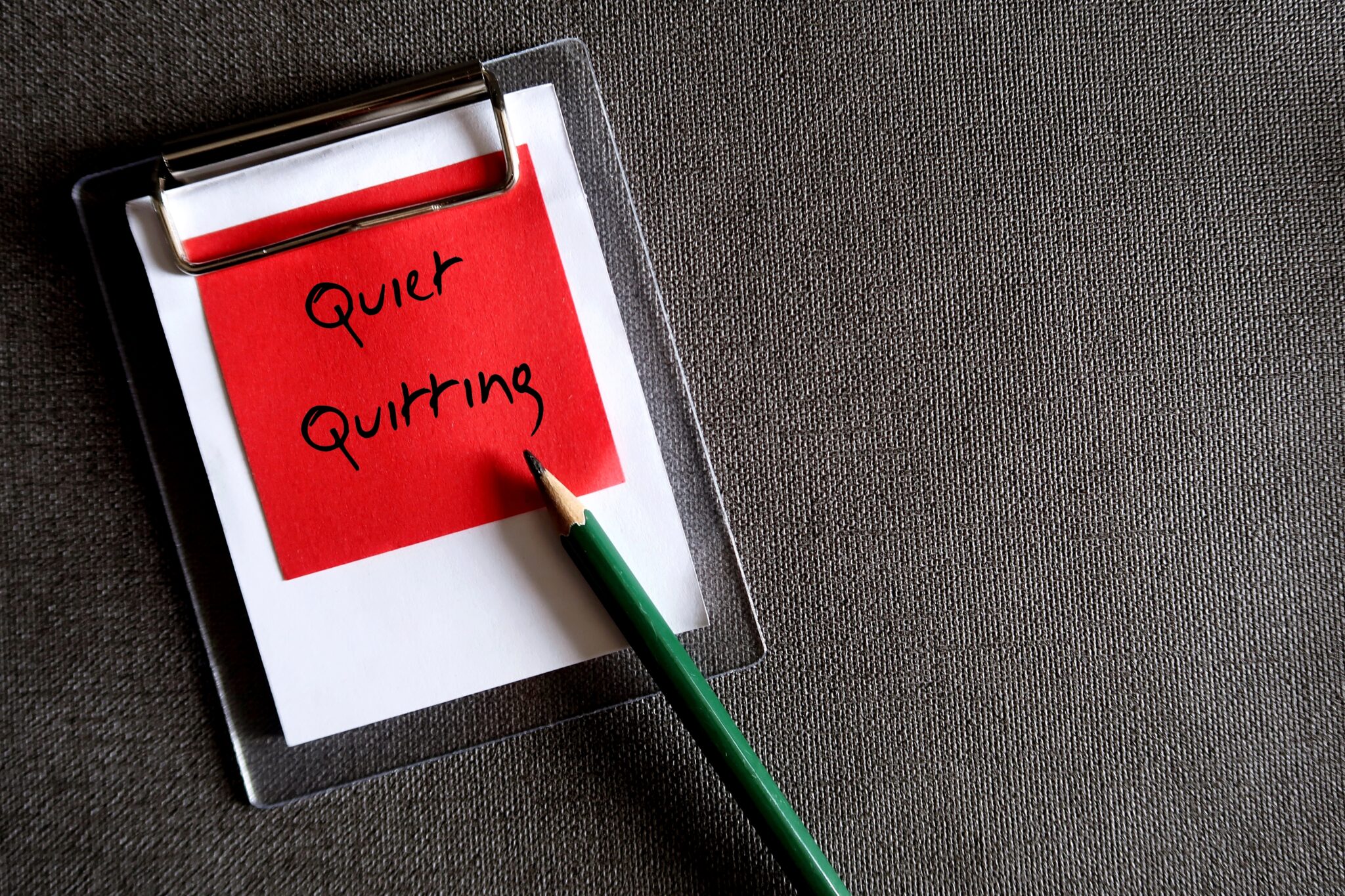 quiet quitting written on a red sticky note