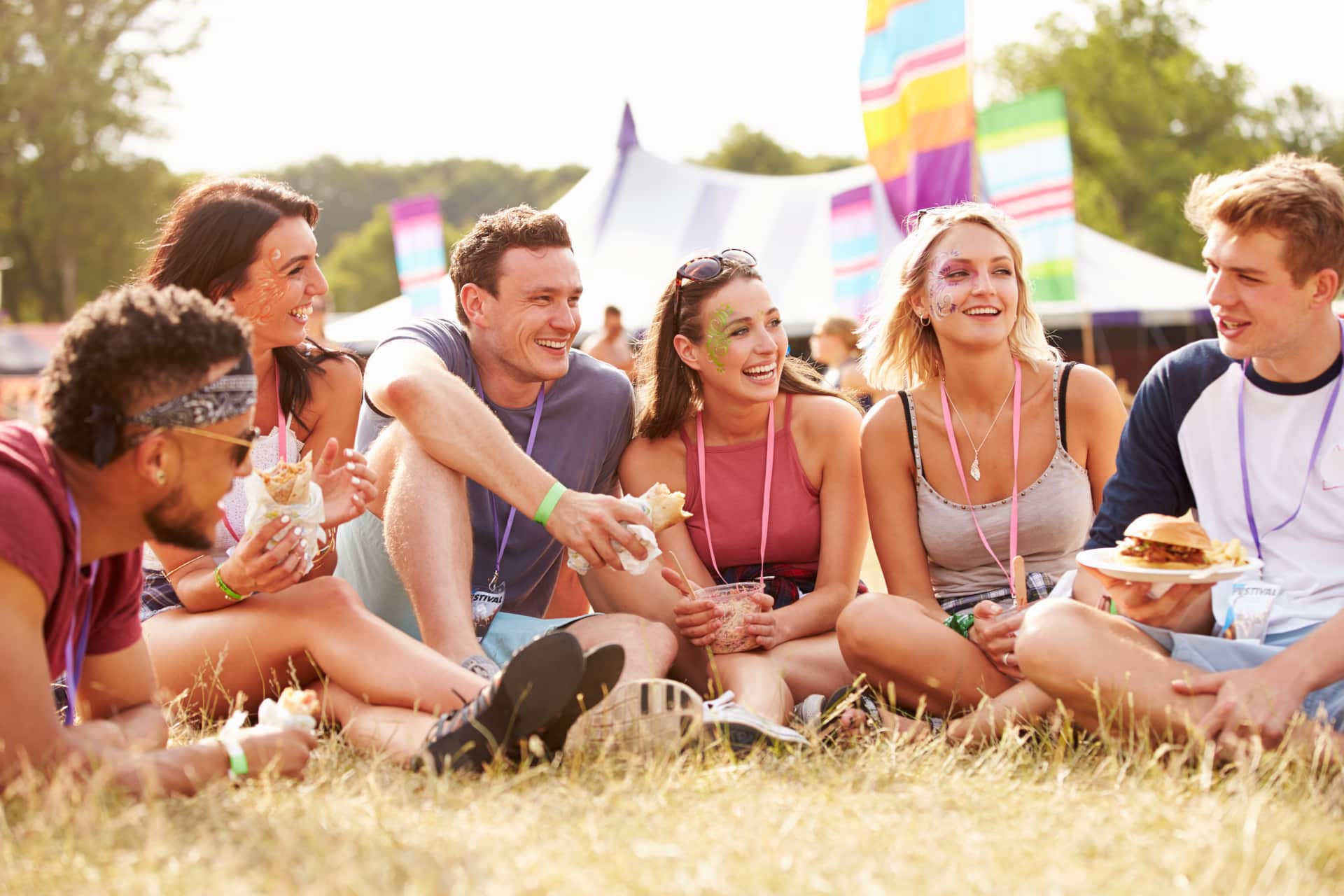 Group of friends sitting on grass at a festival