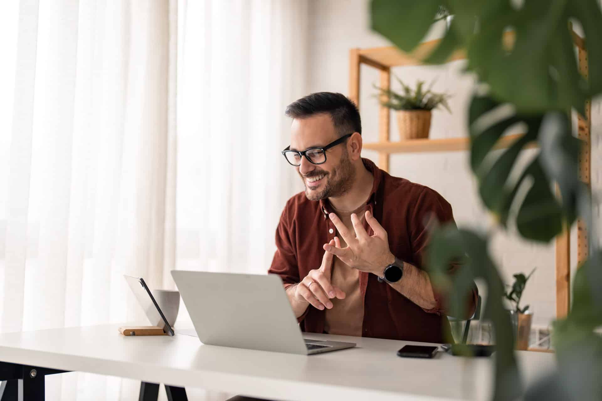 Hybrid working guy on laptop at home